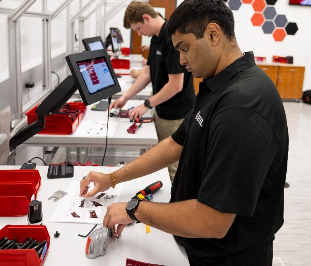 UGA Innovation Factory students at workstations using tools and looking at monitors