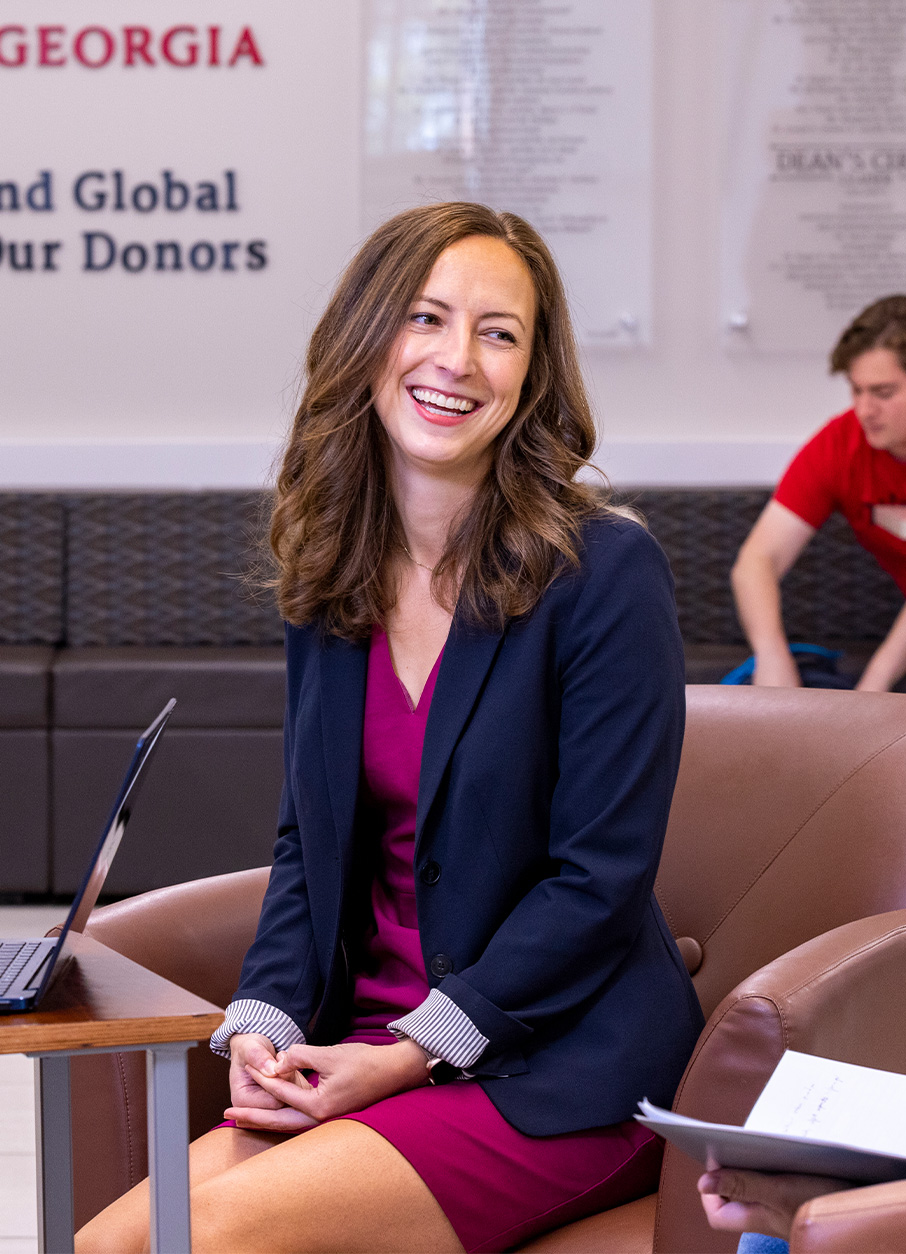 Emily Lawler talks with graduate students Victoria Bethel and Miguel Estrada at Baldwin Hall.