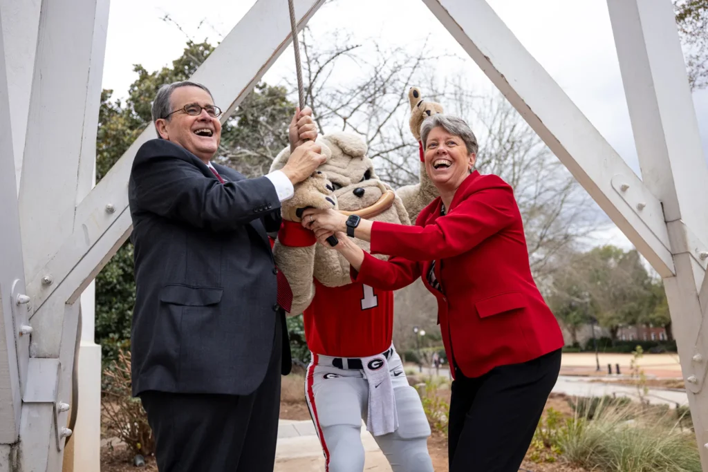 UGA President Jere W. Morehead, mascot Hairy Dawg and UGA School of Medicine Founding Dean Shelley Nuss ring the Chapel Bell in celebration of this milestone.