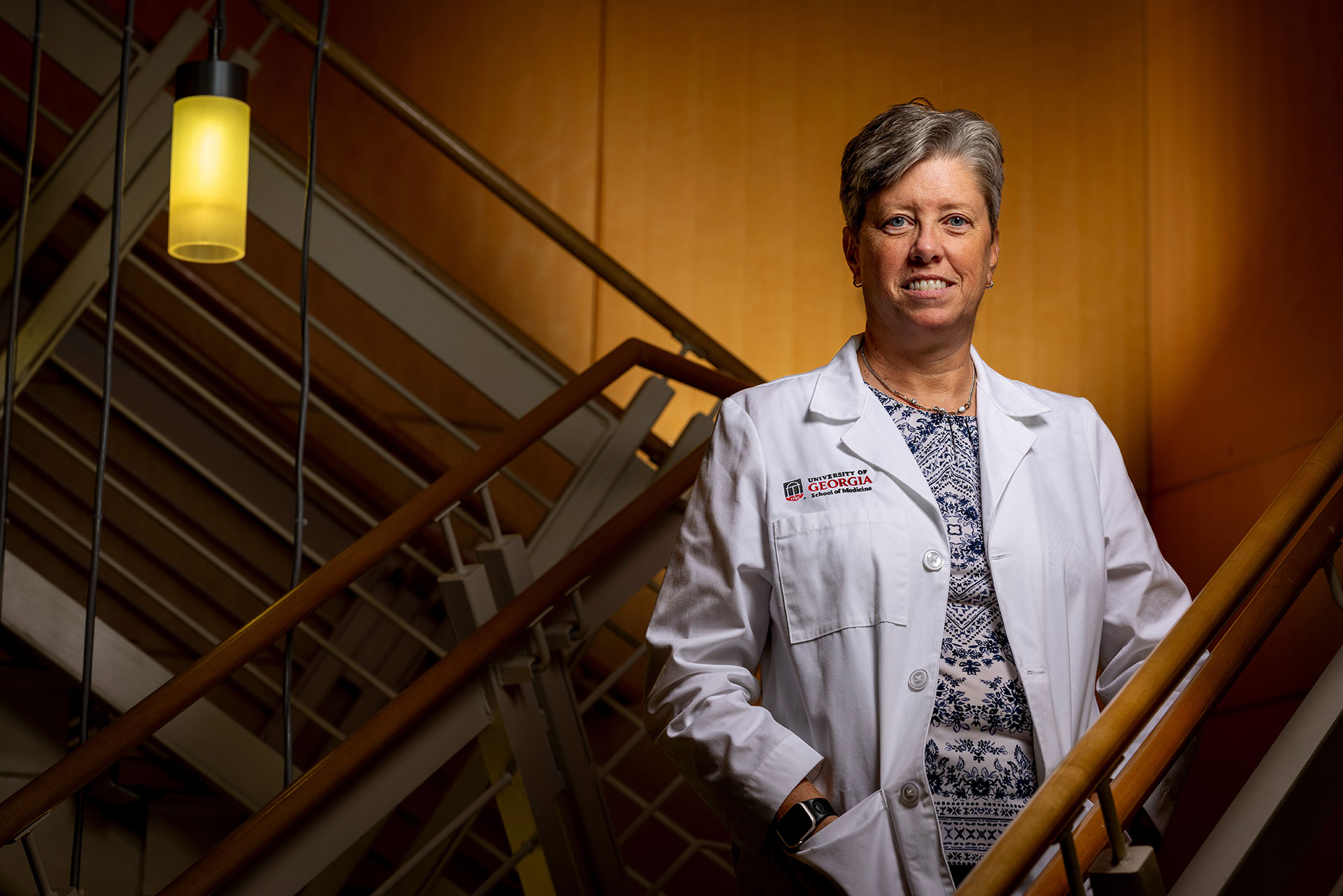 Dr. Shelley Nuss, dean of the UGA School of Medicine - standing for a portrait in a stairwell at the University of Georgia campus