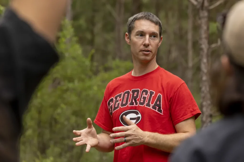 A close-up of a professor in a red 